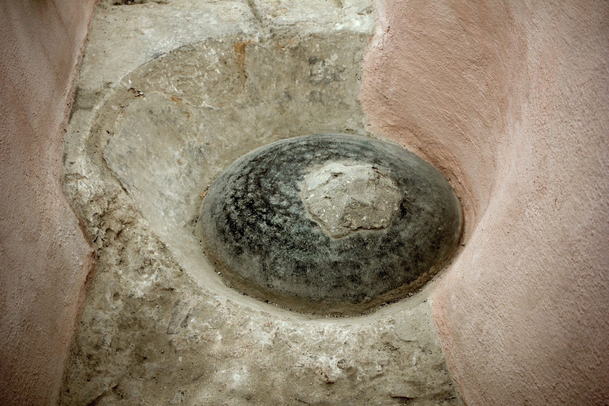 Weathered stone basin set into a hammam wall
